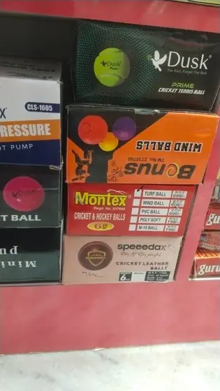 Cricket leather balls, tennis balls and wind balls in boxes