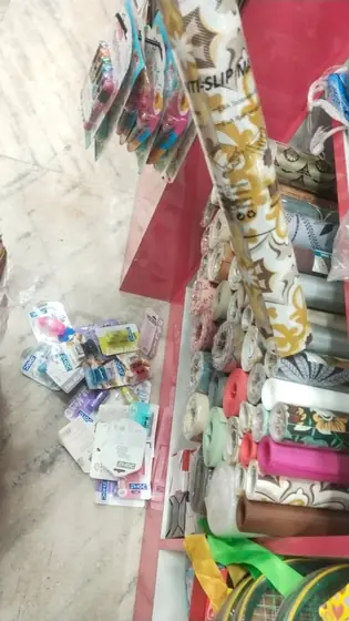 Gift wrapping paper rolls, ribbons and bows kept at the counter