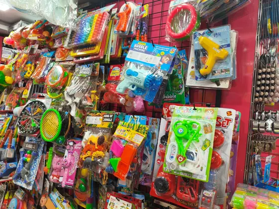 Hanging toy display with puzzles, rackets and play sets