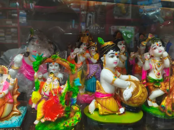 Krishna and deity idols on the showcase shelf
