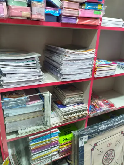 Stacks of long books, ruled notebooks and spiral pads