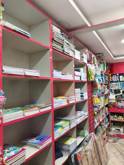 Floor-to-ceiling shelves of notebooks and long books at Bajrang Stationary, Pragathi Nagar
