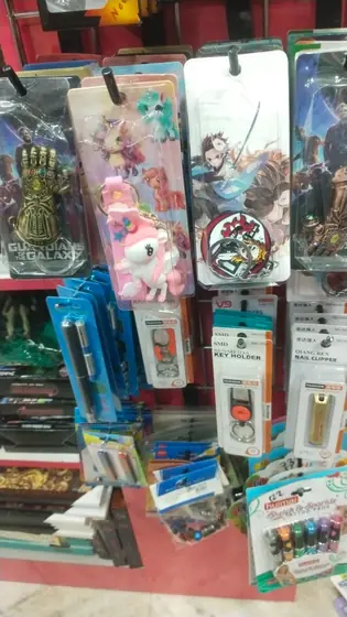 Hanging display of pens, pencil pouches and keychains