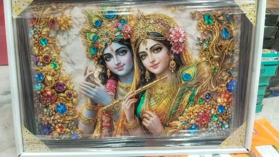 Framed Radha Krishna wall picture with an embellished border