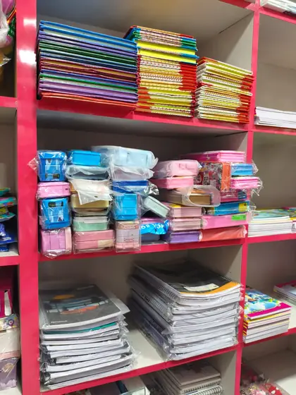 Four-line, square-ruled and single-line notebooks stacked by size